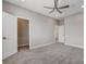 Bedroom featuring neutral carpet, ceiling fan, and two entryways at 6 Lilla Rosa St, Henderson, NV 89011