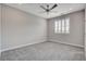 Bright bedroom with large window, shutter blinds, neutral carpet, and ceiling fan at 6 Lilla Rosa St, Henderson, NV 89011