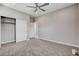 Spacious bedroom featuring neutral carpet, ceiling fan, and closet with sliding doors at 6 Lilla Rosa St, Henderson, NV 89011