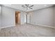 Large bedroom featuring a ceiling fan, tile flooring, and multiple doorways to closets and bathrooms at 6 Lilla Rosa St, Henderson, NV 89011