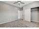 This bedroom features carpet floors, neutral walls, ceiling fan and a closet with sliding doors at 6 Lilla Rosa St, Henderson, NV 89011