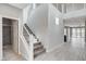 Welcoming foyer with modern staircase, tile floors and access to other areas of the home at 6 Lilla Rosa St, Henderson, NV 89011
