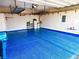 Spacious garage featuring epoxy flooring, water tank, shelves, and overhead storage racks at 6 Lilla Rosa St, Henderson, NV 89011