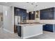 Modern kitchen featuring navy cabinets, a stylish island, and stainless steel appliances at 6 Lilla Rosa St, Henderson, NV 89011