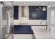 Bright kitchen featuring navy cabinets, stainless steel appliances, and a stylish backsplash at 6 Lilla Rosa St, Henderson, NV 89011