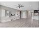 Spacious living room with modern wall-mounted storage, tv area and open access to the kitchen at 6 Lilla Rosa St, Henderson, NV 89011