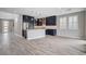 Spacious open-concept living area with modern kitchen, tile floors, and natural light at 6 Lilla Rosa St, Henderson, NV 89011