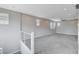 Spacious loft area with neutral tones, plush carpeting, and abundant natural light from multiple windows at 6 Lilla Rosa St, Henderson, NV 89011
