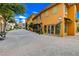 Vibrant street view of storefronts with colorful facades, decorative flower arrangements, and outdoor seating areas at 6 Lilla Rosa St, Henderson, NV 89011
