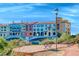 Beautiful waterfront property with colorful architecture, water views, and seating area at 6 Lilla Rosa St, Henderson, NV 89011