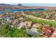 Aerial view featuring a home, golf course, lake, and mountains in a luxury community at 6 Rue Du Ville Way, Henderson, NV 89011