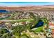 Beautiful aerial shot of a community with a golf course and lake, set against a desert landscape at 6 Rue Du Ville Way, Henderson, NV 89011