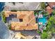 Top-down view of a private home with a sparkling pool, green lawn, and elegant outdoor living spaces at 6 Rue Du Ville Way, Henderson, NV 89011