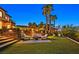 Backyard fire pit and seating area with meticulous landscaping provides a lovely outdoor retreat at 6 Rue Du Ville Way, Henderson, NV 89011