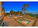 A modern outdoor pool and spa area surrounded by pavers, lounge chairs, and palm trees at 6 Rue Du Ville Way, Henderson, NV 89011