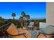 Balcony with comfortable seating, palm trees, and scenic views of the neighborhood at 6 Rue Du Ville Way, Henderson, NV 89011