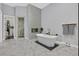 Modern bathroom with a soaking tub, glass shower and marble floors at 6 Rue Du Ville Way, Henderson, NV 89011