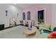 Pink bedroom with a quaint seating area, desk, and a charming balcony overlooking a tropical view at 6 Rue Du Ville Way, Henderson, NV 89011