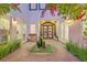 Inviting entrance featuring a stone archway and manicured landscaping at 6 Rue Du Ville Way, Henderson, NV 89011