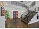 Grand foyer with a curved staircase and modern lighting at 6 Rue Du Ville Way, Henderson, NV 89011