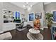 Cozy living room featuring hardwood floors, custom built-ins, modern lighting, and a comfortable seating area at 6 Rue Du Ville Way, Henderson, NV 89011