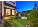 Exterior patio featuring synthetic turf, a modern outdoor tub, and privacy landscaping at 6 Rue Du Ville Way, Henderson, NV 89011
