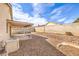 Low-maintenance backyard with a covered patio, block fence, gravel landscaping and an AC unit at 620 Macbrey Dr, Las Vegas, NV 89123