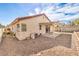 Exterior view of a home featuring a covered patio and low-maintenance gravel landscaping at 620 Macbrey Dr, Las Vegas, NV 89123