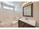 A bright bathroom featuring a vanity with a white countertop and a shower/bathtub combination at 620 Macbrey Dr, Las Vegas, NV 89123
