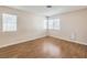 An airy bedroom with wood-look floors, two windows, and neutral walls at 620 Macbrey Dr, Las Vegas, NV 89123