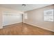Bedroom featuring an open closet, wood-look floors, and two windows at 620 Macbrey Dr, Las Vegas, NV 89123
