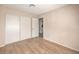 Bedroom with wood-look floors, neutral walls, and a closet with sliding doors at 620 Macbrey Dr, Las Vegas, NV 89123