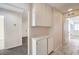 Hallway featuring cabinets and tile flooring, with doorways leading to other rooms at 620 Macbrey Dr, Las Vegas, NV 89123