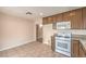 A kitchen featuring tile floors, granite countertops and a white gas range at 620 Macbrey Dr, Las Vegas, NV 89123