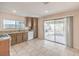 Well-lit kitchen with granite countertops and access to the backyard through sliding glass doors at 620 Macbrey Dr, Las Vegas, NV 89123
