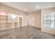 Large living room with built-in shelving, tile flooring, and ample natural light at 620 Macbrey Dr, Las Vegas, NV 89123