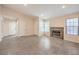 Spacious living room featuring a stone fireplace, tiled flooring, and large windows at 620 Macbrey Dr, Las Vegas, NV 89123