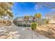 Fenced tennis court for community use with walkway and mature landscaping at 620 Macbrey Dr, Las Vegas, NV 89123
