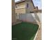 Backyard featuring artificial grass and low maintenance landscaping, perfect for relaxation and outdoor activities at 6476 Ness Gardens Ct, Las Vegas, NV 89122