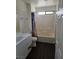 Bathroom featuring a tub with shower, vanity, toilet and wood-look flooring at 6476 Ness Gardens Ct, Las Vegas, NV 89122