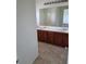 Bathroom features a double sink vanity with wooden cabinets and a large mirror at 6476 Ness Gardens Ct, Las Vegas, NV 89122