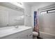 A bathroom with white cabinetry, a toilet, and a tub-shower combo with a patterned curtain at 6476 Ness Gardens Ct, Las Vegas, NV 89122