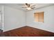 Cozy bedroom with wood floors, ceiling fan, and natural light from a window at 6476 Ness Gardens Ct, Las Vegas, NV 89122