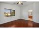 A bedroom with wood floors and a window with views, next to a door leading to the bathroom at 6476 Ness Gardens Ct, Las Vegas, NV 89122