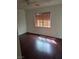 Bedroom showcasing hardwood floors and window with blinds that provide natural light at 6476 Ness Gardens Ct, Las Vegas, NV 89122