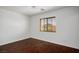 Bright bedroom with wood floors, a ceiling fan, and a window with blinds overlooking the neighborhood at 6476 Ness Gardens Ct, Las Vegas, NV 89122