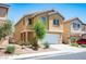 Attractive two-story home with a two-car garage, desert landscaping, and mature trees at 6476 Ness Gardens Ct, Las Vegas, NV 89122