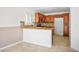 Well-lit kitchen features stylish cabinets and granite countertops with tile backsplash at 6476 Ness Gardens Ct, Las Vegas, NV 89122