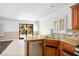 Kitchen with granite counters, stainless steel appliances, and access to backyard at 6476 Ness Gardens Ct, Las Vegas, NV 89122