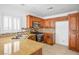 Modern kitchen with stainless steel appliances, granite counters, and wooden cabinets at 6476 Ness Gardens Ct, Las Vegas, NV 89122